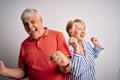 Senior beautiful couple standing together over isolated white background Dancing happy and cheerful, smiling moving casual and Royalty Free Stock Photo