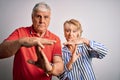 Senior beautiful couple standing together over isolated white background Doing time out gesture with hands, frustrated and serious Royalty Free Stock Photo