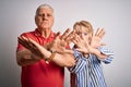 Senior beautiful couple standing together over isolated white background Rejection expression crossing arms and palms doing Royalty Free Stock Photo