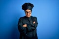 Senior beautiful grey-haired chef woman wearing cooker uniform and hat over blue background skeptic and nervous, disapproving Royalty Free Stock Photo