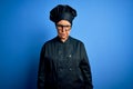 Senior beautiful grey-haired chef woman wearing cooker uniform and hat over blue background skeptic and nervous, frowning upset Royalty Free Stock Photo