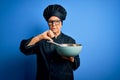 Senior beautiful grey-haired chef woman wearing cooker uniform and hat using whisk and bowl with angry face, negative sign showing Royalty Free Stock Photo