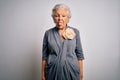 Senior beautiful grey-haired woman wearing casual dress standing over white background sticking tongue out happy with funny Royalty Free Stock Photo