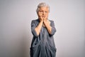 Senior beautiful grey-haired woman wearing casual dress standing over white background Tired hands covering face, depression and Royalty Free Stock Photo