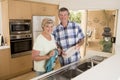 Senior beautiful middle age couple around 70 years old smiling happy at home kitchen washing the dishes looking sweet together Royalty Free Stock Photo