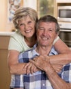 Senior beautiful middle age couple around 70 years old smiling happy together at home kitchen looking sweet in lifetime husband an Royalty Free Stock Photo