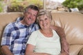 Senior beautiful middle age couple around 70 years old smiling happy together at home living room sofa couch looking sweet in life Royalty Free Stock Photo