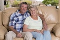 Senior beautiful middle age couple around 70 years old smiling happy together at home living room sofa couch looking sweet in life Royalty Free Stock Photo