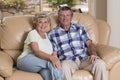 Senior beautiful middle age couple around 70 years old smiling happy together at home living room sofa couch looking sweet in life Royalty Free Stock Photo