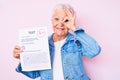 Senior beautiful woman with blue eyes and grey hair showing a passed exam smiling happy doing ok sign with hand on eye looking Royalty Free Stock Photo