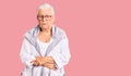 Senior beautiful woman with blue eyes and grey hair wearing casual clothes and glasses with hand on stomach because indigestion, Royalty Free Stock Photo