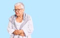 Senior beautiful woman with blue eyes and grey hair wearing casual clothes and glasses with hand on stomach because nausea, Royalty Free Stock Photo