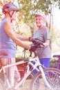 Senior bicycle rider looking at senior man in park