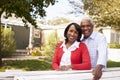 Senior black couple look to camera outside their new house Royalty Free Stock Photo