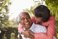 Senior black couple piggyback, looking at each other Royalty Free Stock Photo