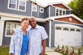 Senior black couple standing outside a large suburban house Royalty Free Stock Photo