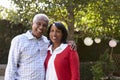 Senior black couple in their garden looking to camera Royalty Free Stock Photo