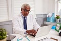 Senior black male doctor in white coat working in an office Royalty Free Stock Photo