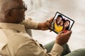 Senior black man calling his family, using digital tablet Royalty Free Stock Photo