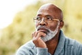 senior, black man and face thinking outdoor in nature to remember memory, idea or vision. Headshot of an elderly male Royalty Free Stock Photo