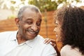 Senior African American  man and his adult granddaughter laughing outdoors, close up Royalty Free Stock Photo