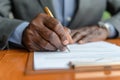 Senior black man signing document, focus on hand with pen Royalty Free Stock Photo