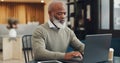 Senior, black man and typing on laptop in coffee shop, research or social media. Cafe, tech and elderly businessman from Royalty Free Stock Photo