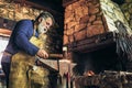 Senior blacksmith forge iron Royalty Free Stock Photo