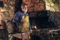 Senior blacksmith forge iron Royalty Free Stock Photo