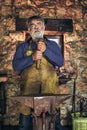 Senior blacksmith forge iron Royalty Free Stock Photo