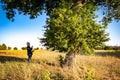 Senior botanist talking with the magic tree at sunset 02