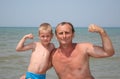 Senior and boy show bicepses Royalty Free Stock Photo