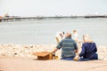 Senior British couple take a picnic by the sea, on Llandudno promenade.