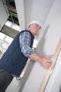 Senior builder installing door