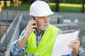 senior builder on phone