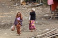 Senior Burmese woman walking in slum Royalty Free Stock Photo