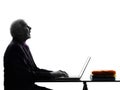 Senior business man computing looking up mouth open silhouette