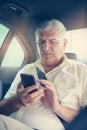 Business man in car. Typing on phone. Royalty Free Stock Photo
