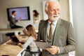 Senior business man working on digital tablet in the office Royalty Free Stock Photo