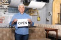 Business owner holding OPEN sign in his restaurant Royalty Free Stock Photo