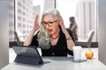 Senior business woman with stress, anxiety, overloaded on computer at the office Royalty Free Stock Photo