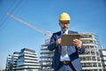senior businessman architect helmet construction site building architecture tablet computer