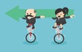 Senior businessman and Businesswoman riding a bicycle holding green arrow