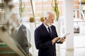 Senior businessman with digital tablet in office Royalty Free Stock Photo