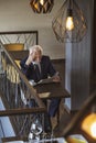 Senior businessman drinking coffee and reading newspaper Royalty Free Stock Photo