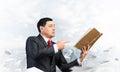 Senior businessman finger pointing into open book Royalty Free Stock Photo