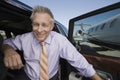 Senior Businessman Getting Down From Car Royalty Free Stock Photo