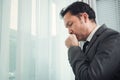 Senior businessman in grey suit coughing. Illness, disease, allergy concepts. Royalty Free Stock Photo