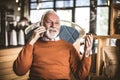 Senior businessman at his home talking phone. Royalty Free Stock Photo