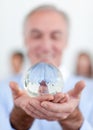 Senior businessman holding a crystal ball